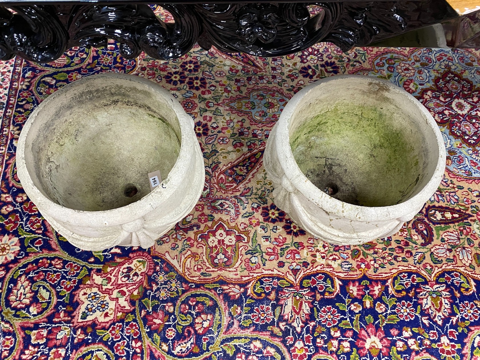 A pair of reconstituted stone circular garden planters with swagged bodies, diameter 38cm, height 30cm.